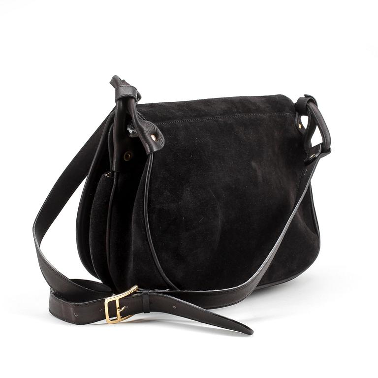 CÈLINE, a black suede handbag.