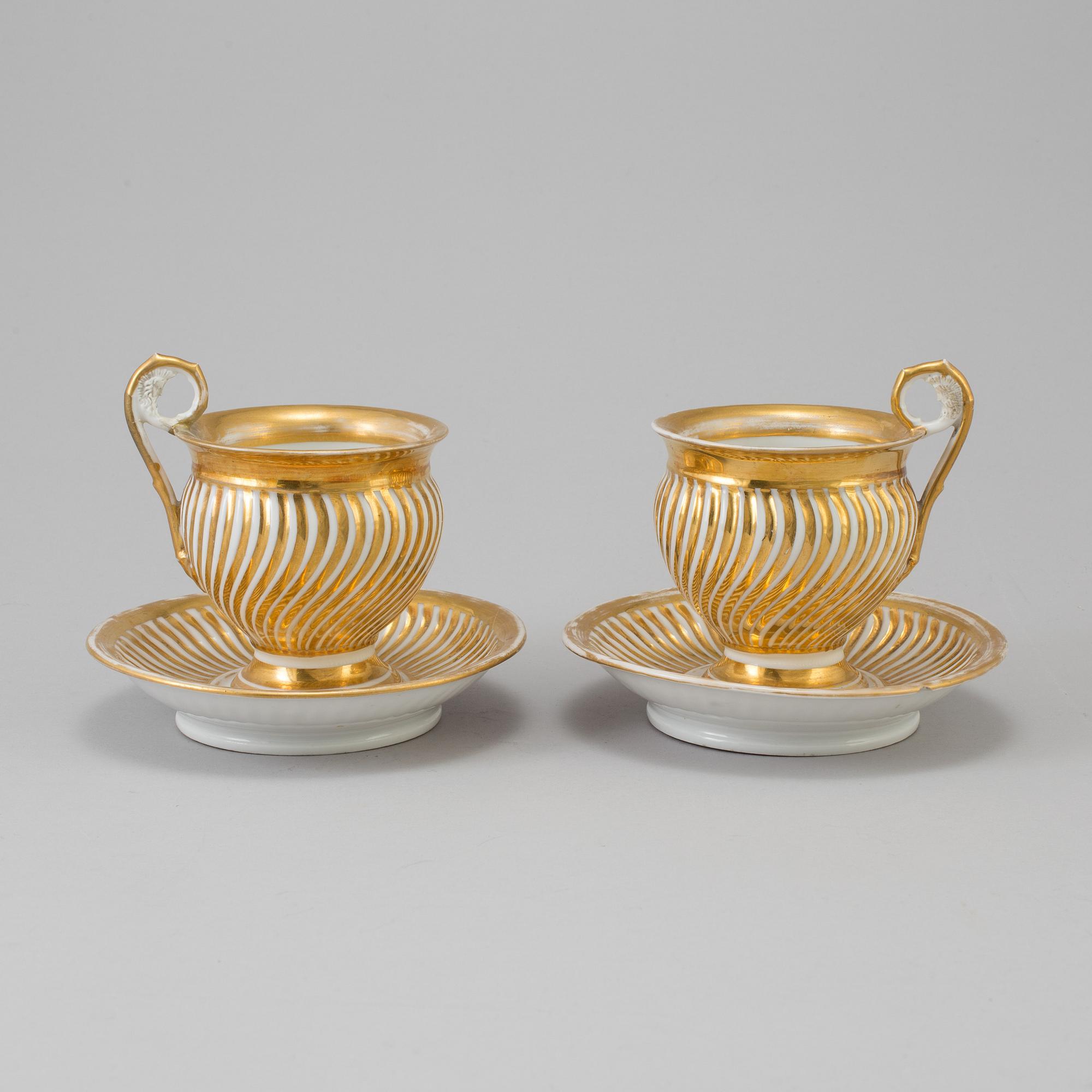 a pair of late empire porcelain cups with saucers from the first half of the 19th century.
