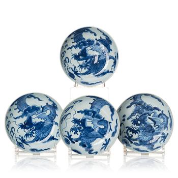 1122. A set of four blue and white dragon dishes, Qing dynasty, 18th Century.