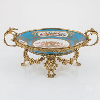 A French porcelain and brass centrepiece, second half of the 19th Century.