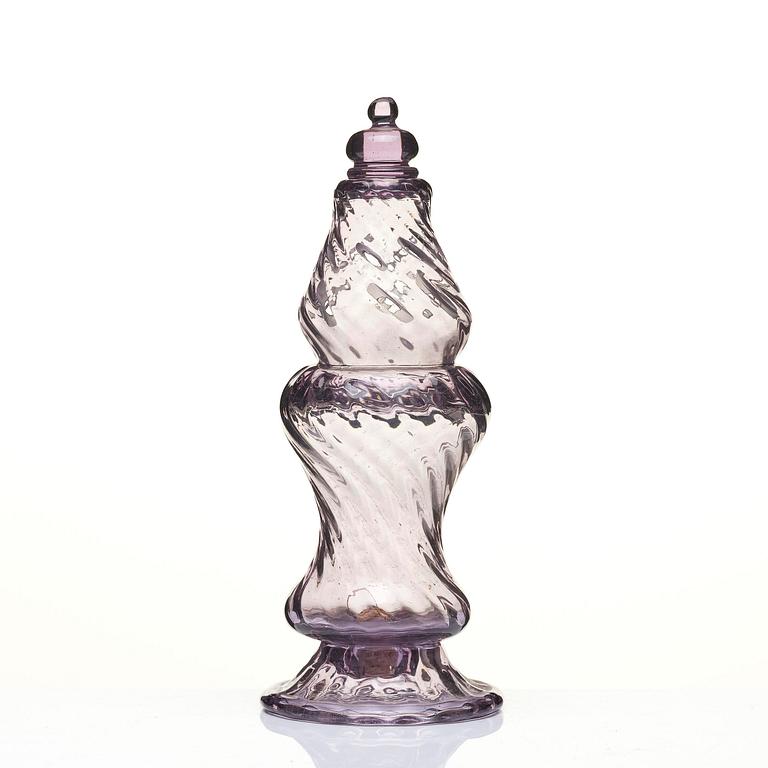 An amethyst coloured suger shaker and a cut glass goblet, 18th century.