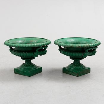 A pair of cast iron garden urns by Husqvarna, circa 1900.