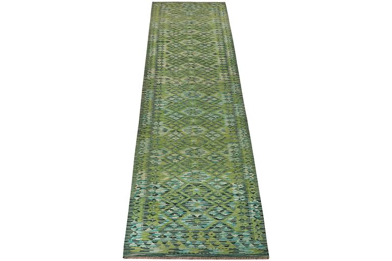 An Afghan kilim runner, c. 488 x 79 cm.