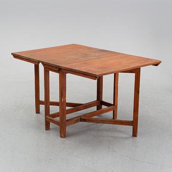 A pine gate leg table, 19th Century.