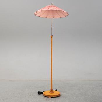 A 1940s birch wood floor lamp.