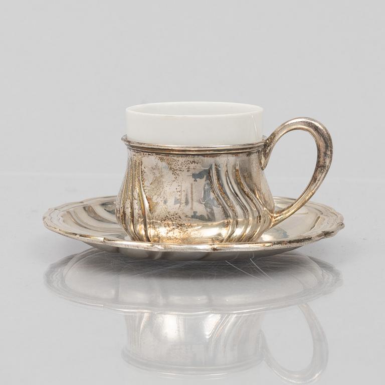 A set of eleven silver cups with saucers and a bowl, Germany, 20th Century.