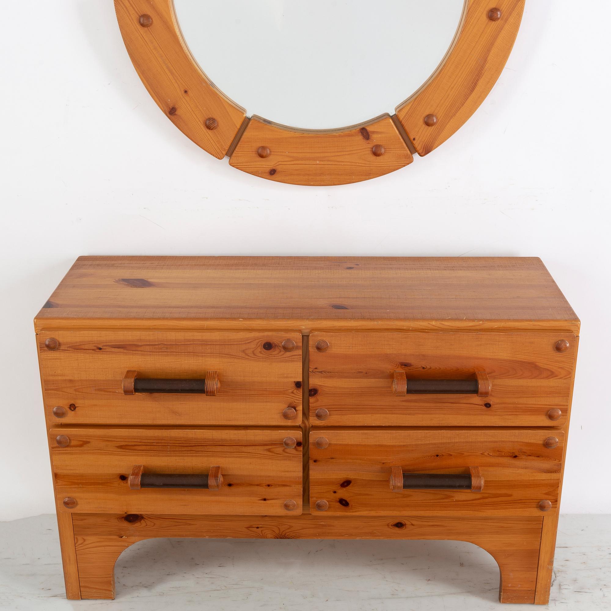 A 1970's set with a pine mirror and chest of drawers.