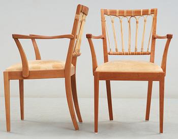 A pair of Josef Frank mahogany and ratten dining chairs.