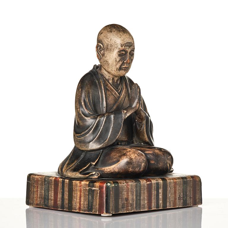 A painted and lacquered wooden sculpture of a monk, Japan, 19th century.