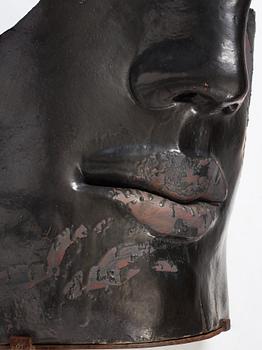 Hertha Hillfon, a black glazed stoneware wall sculpture in two parts of a face and a sky, executed in her own studio, Stockholm 1960s.