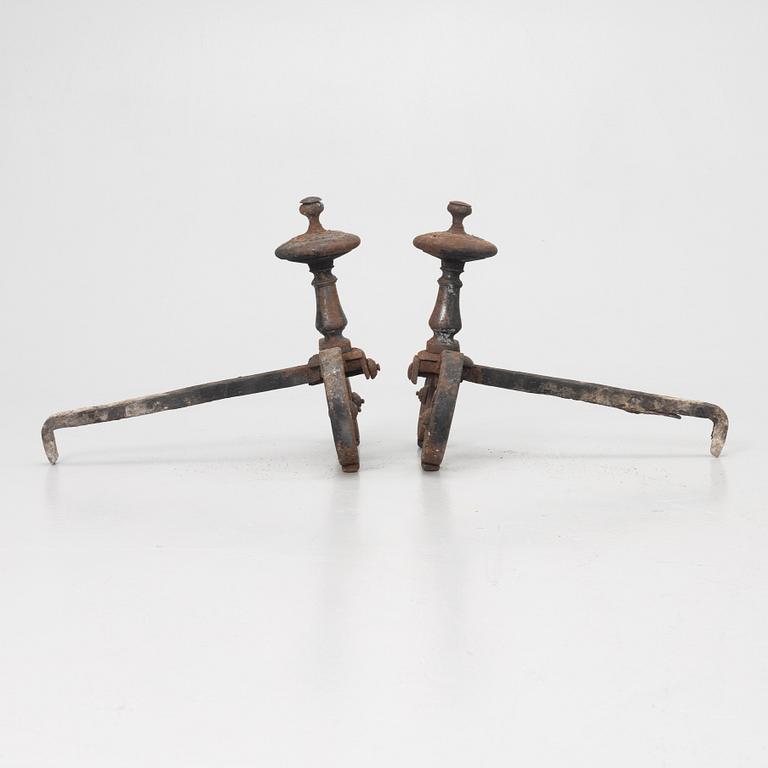 A pair of wrought iron fire dogs.