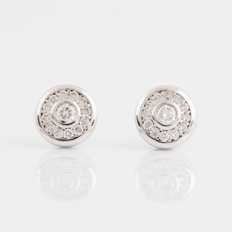 A pair of 14K gold earrings set with round brilliant-cut diamonds.