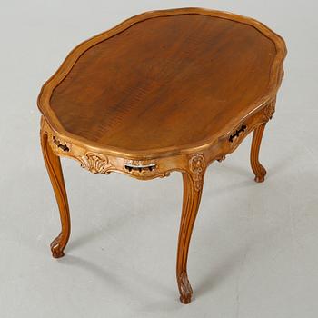 A rococo style sofa, two lounge chairs and a table, around the year 1900 and first half of the 20th century.