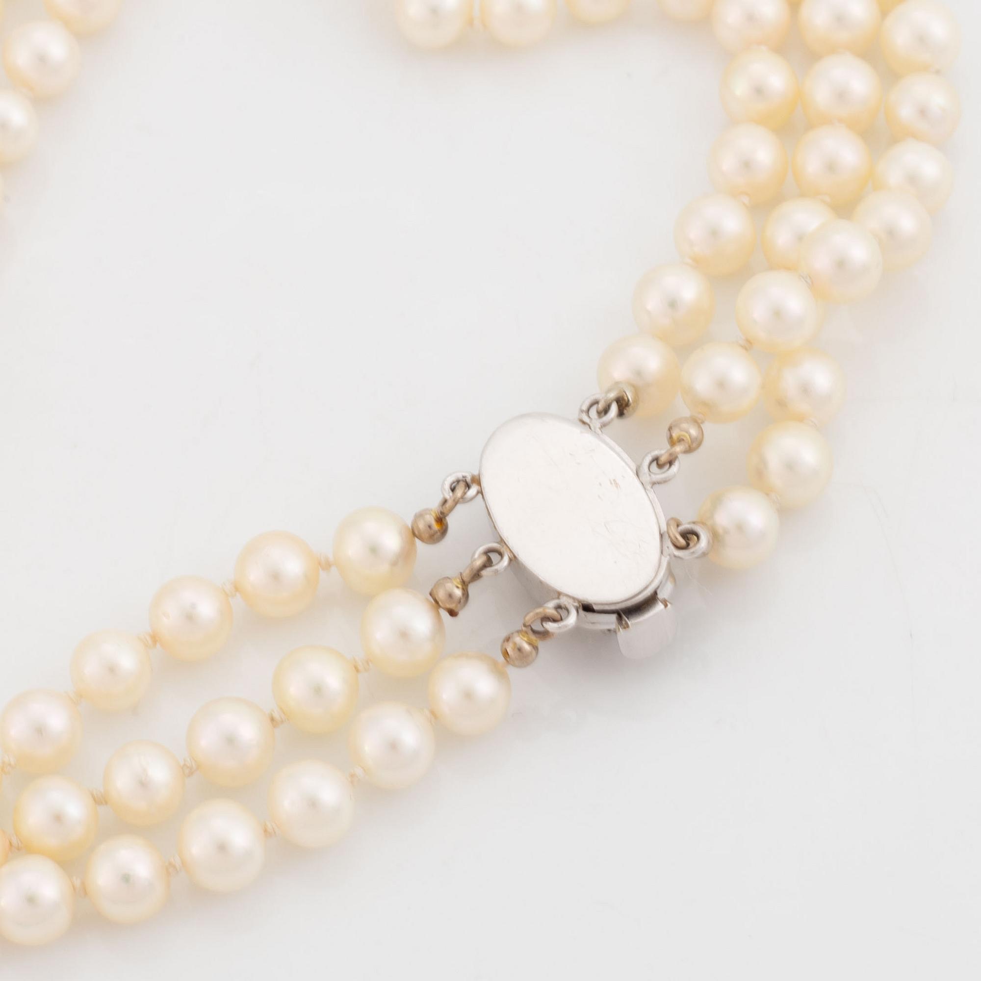 Three strand cultured pearl necklace, clasp with diamonds.