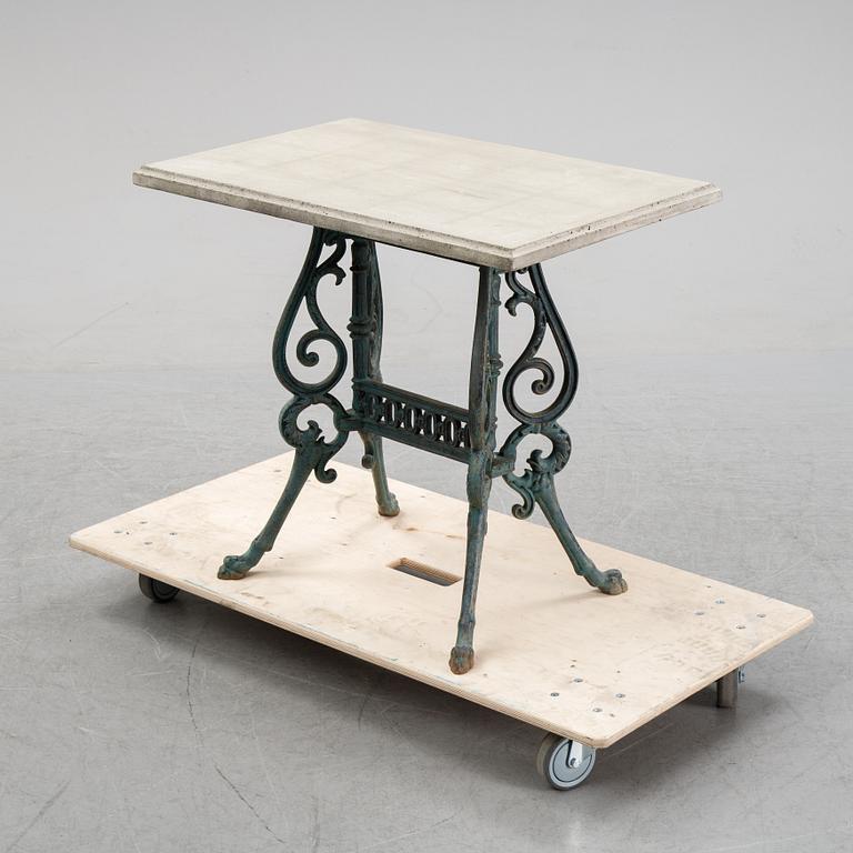 A early 20th Century cast iron garden table with later concrete top.