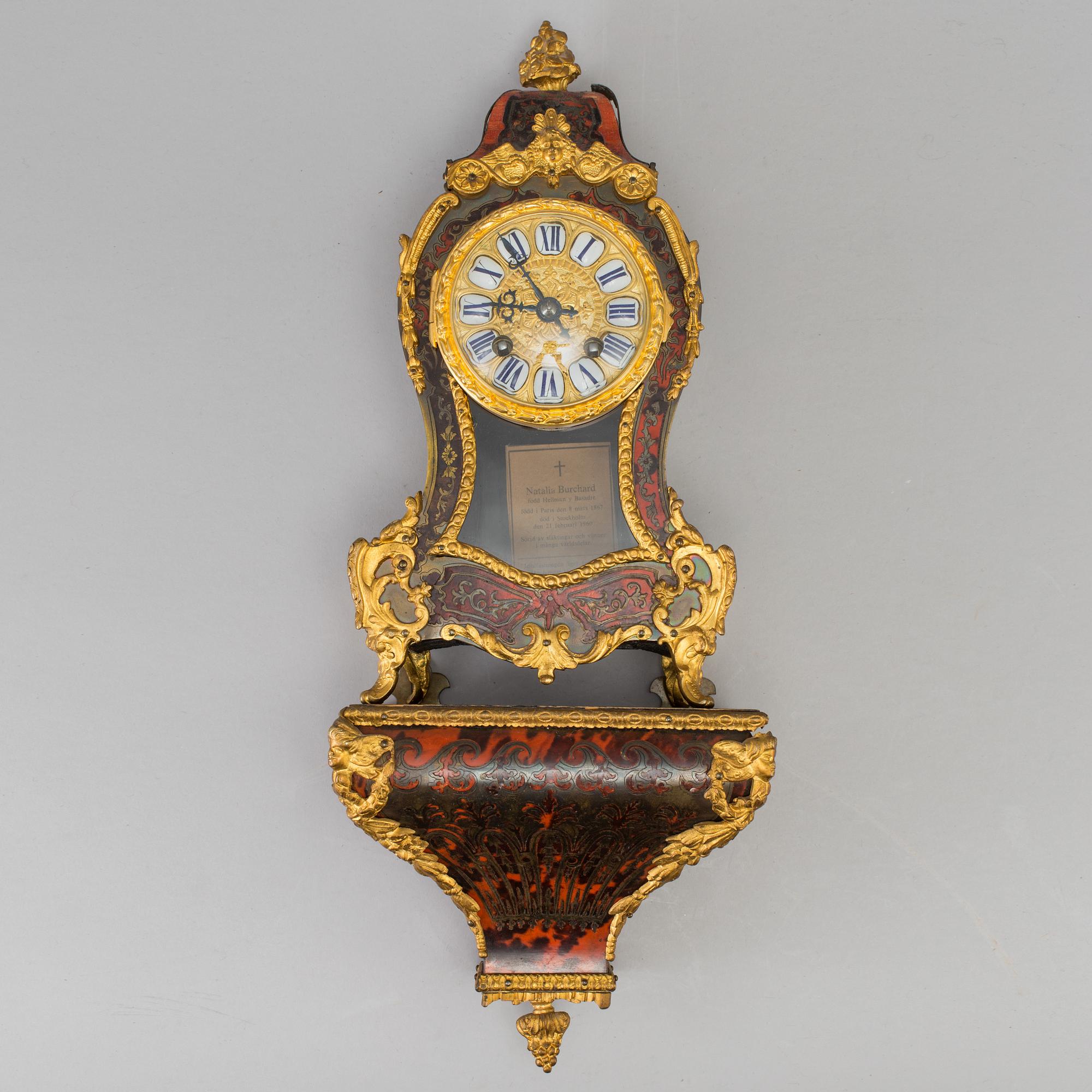 A Louis XV-style mantle clock with console base.