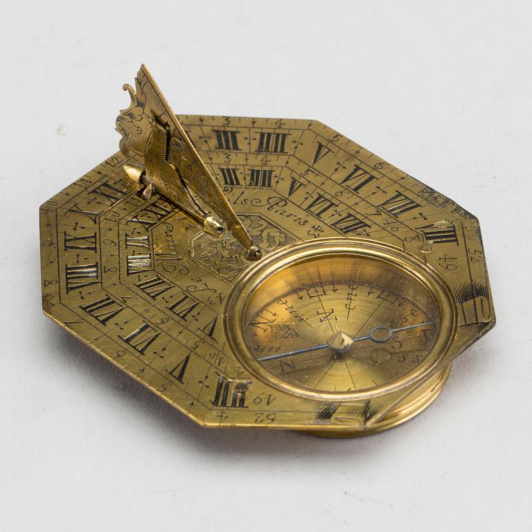 A brass travel sundial marked Le Maire et Fils Paris around 1700.