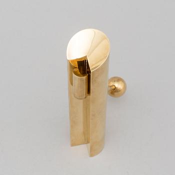 A brass candle holder by Pierre Forssell for Skultuna.