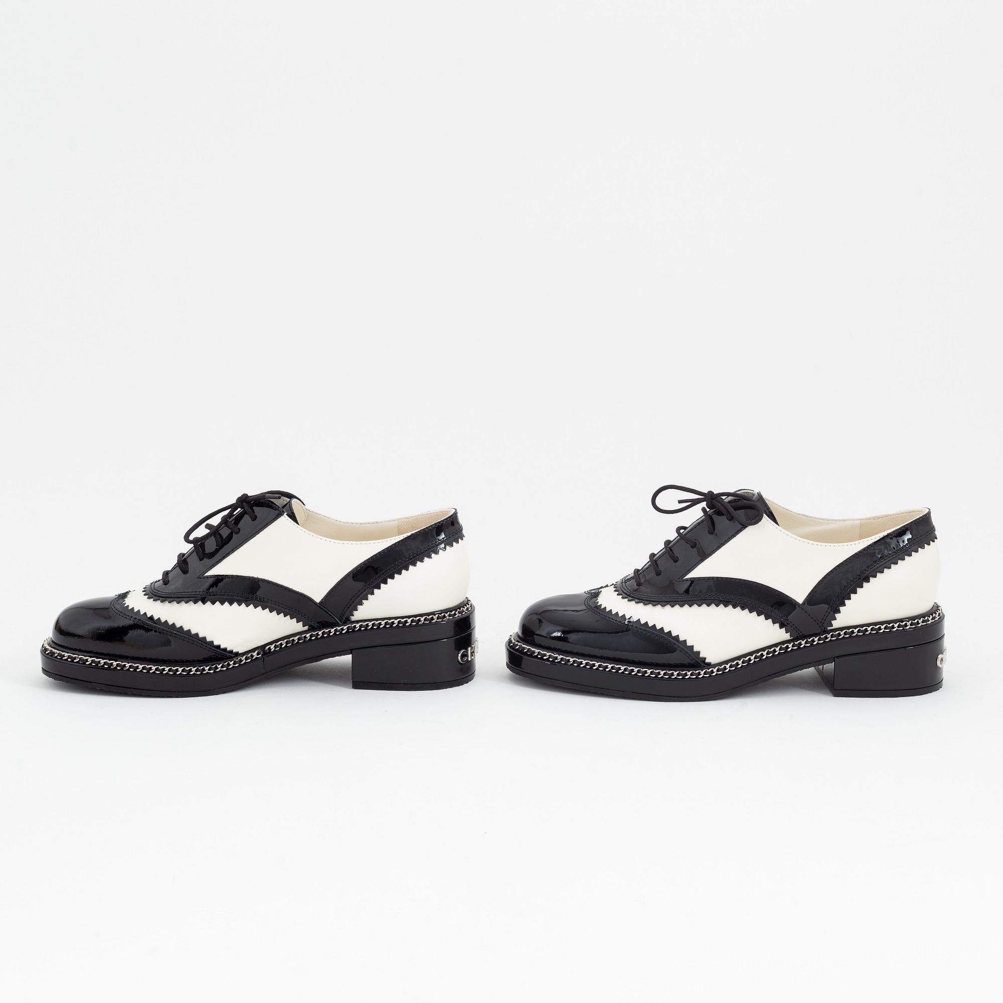 Chanel, a pair of black and white leather brogues, size 39½.