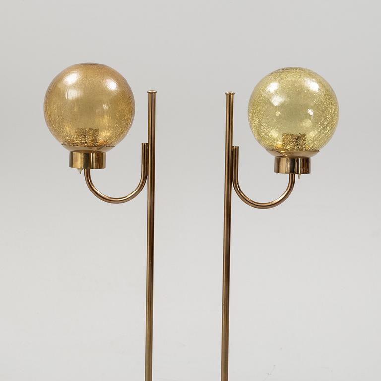 Bergboms, a pair of model 'G-118', brass and glass floor lamps. Second half of the 20th century.