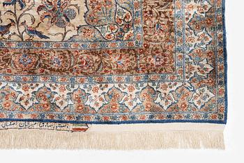 A semi-antique silk Isfahan rug, Central Persia, signed (Sadegh) Seirafian, c. 209 x 142 cm.
