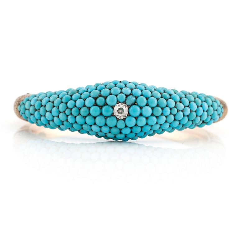 An 18K gold bracelet with turquoises and an old-cut diamond.