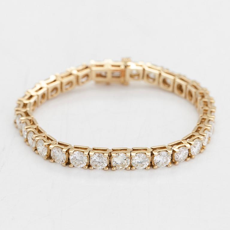 A 14K gold tennis bracelet, with brilliant-cut diamonds totalling approximately 12.00 ct.