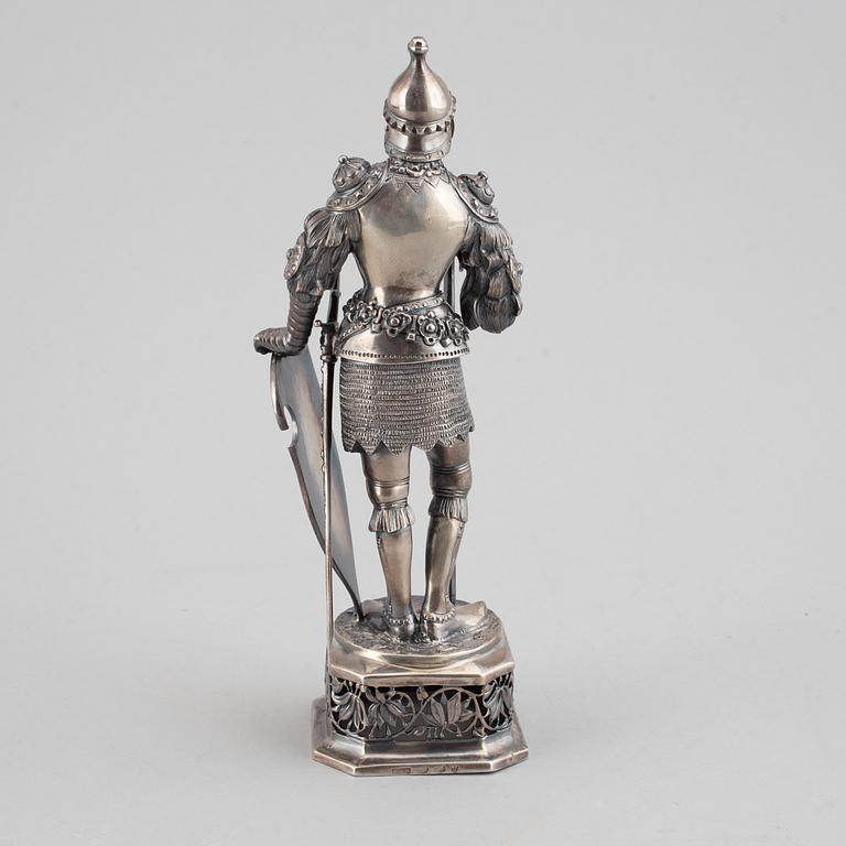 A silver knight figurine in case, pseudo marks.