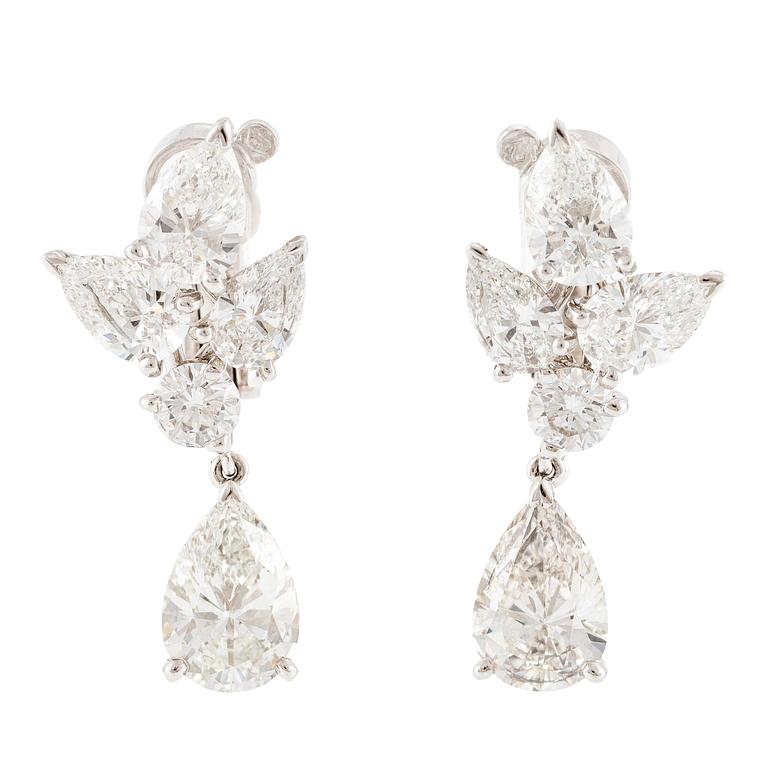 Cartier a pair of earrings platinum set with drop-shaped and round brilliant-cut diamonds.