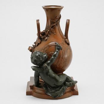 A patinated bronze vase after Auguste Moreau, made around year 1900.