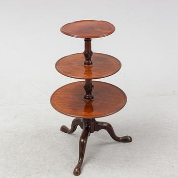 A mahogany three-tier table, England, circa 1900.