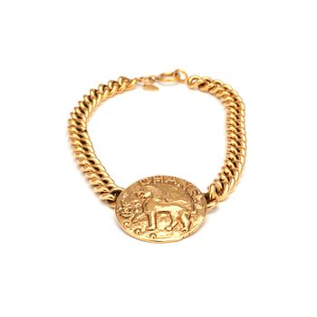 CHANEL, a gold colored chain necklace with medallion.