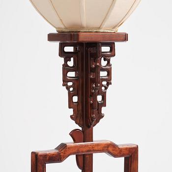 A Chinese wooden floor lamp, later part of the 20th century.