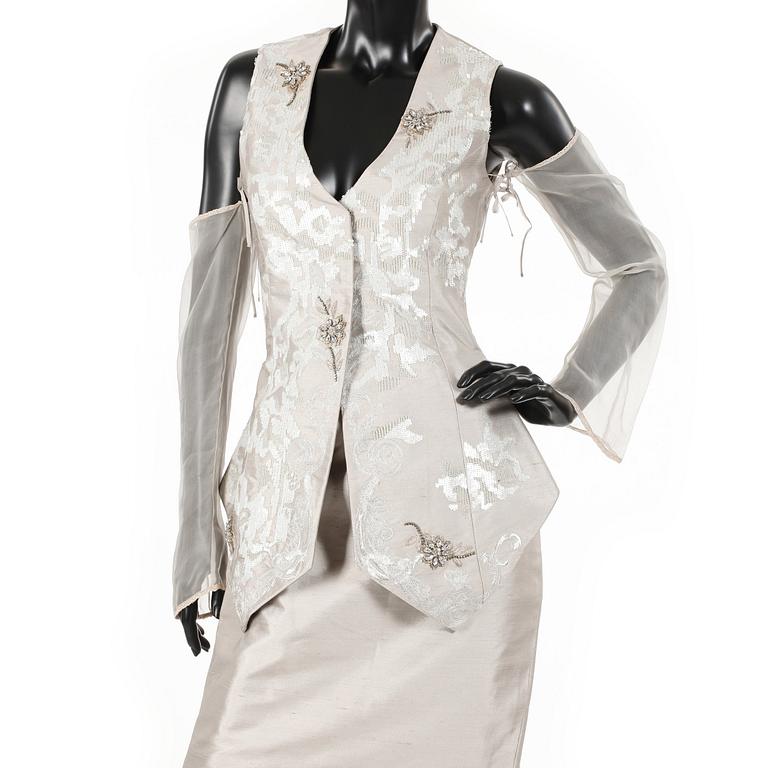 GIANFRANCO FERRÉ, a beige three-piece ensemble consisting of vest , trousers and skirt.