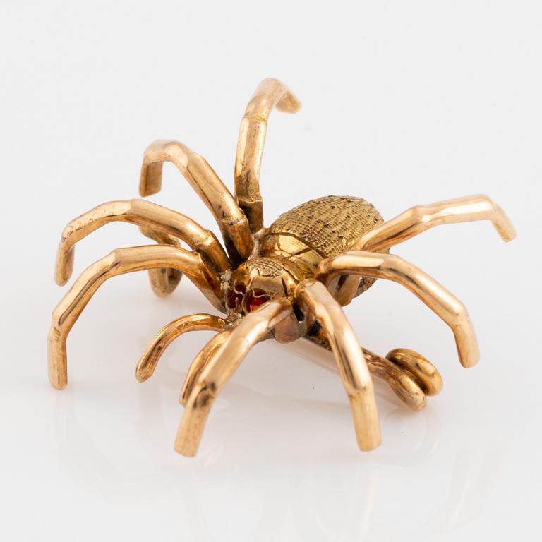 Gold spider brooch.