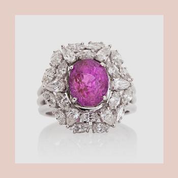 1111. RING, with a pink sapphire, circa 4 cts, marquise and pearshaped diamonds circa 1.54 ct .