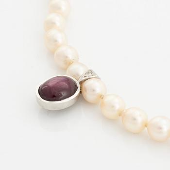 Cultured pearl necklace and cabochon cut ruby pendant.