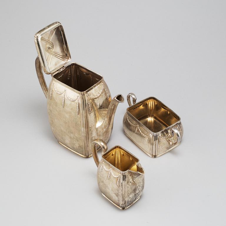 K ANDERSON, a three-piece parcel-gilt silver coffee set from Stockholm, 1911.