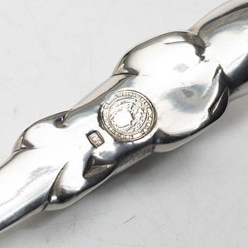 Firma Svenskt Tenn, Candelabrum, 'Vänskapsknuten', and paper knife, 'Alligator'.