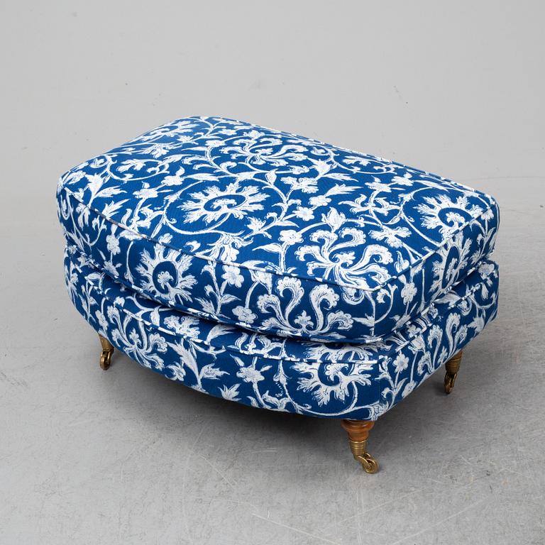 A pair of easy chairs and a stool.