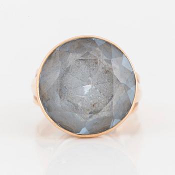 A 14K gold and synthetic blue spinel ring.