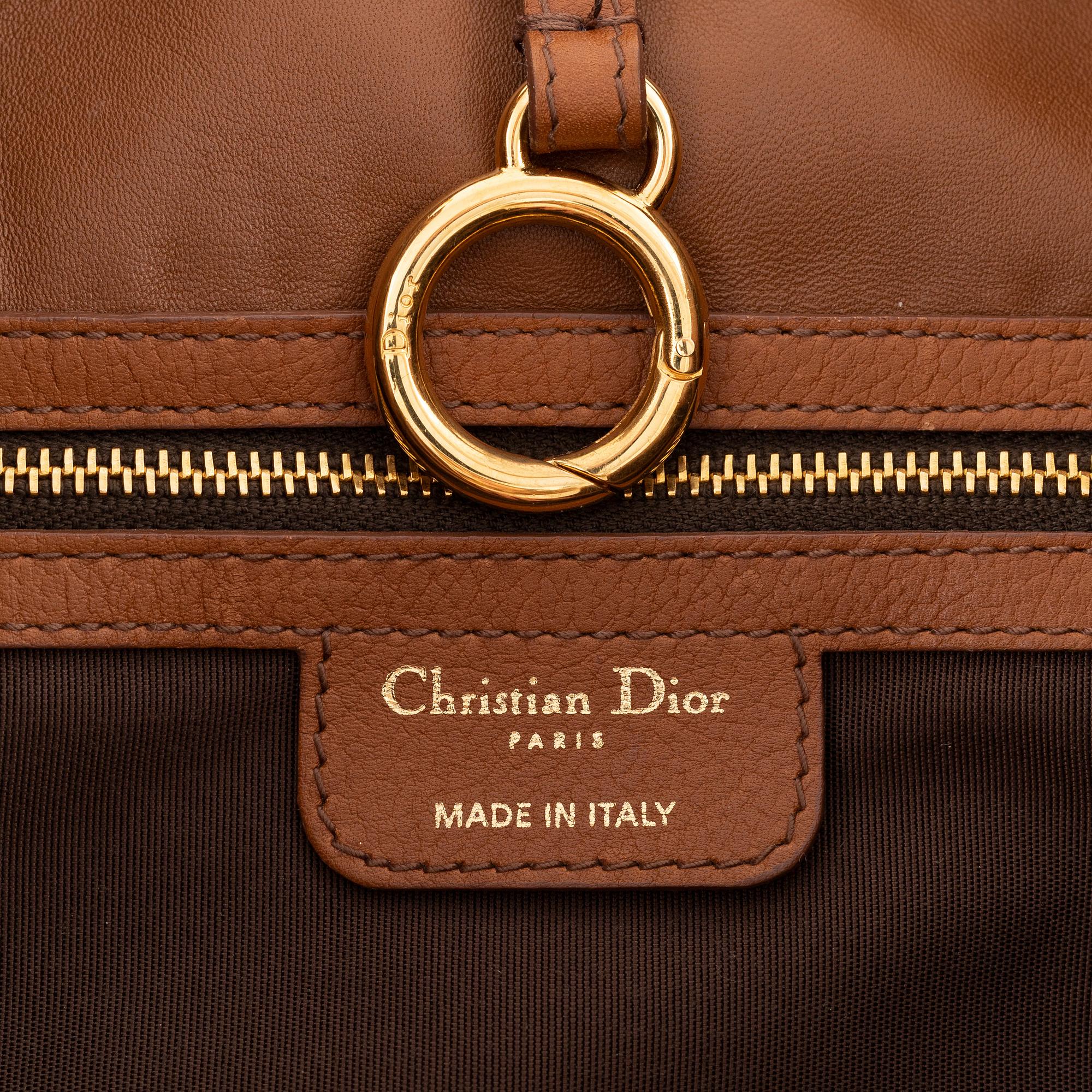 Christian Dior, a brown leather handbag.