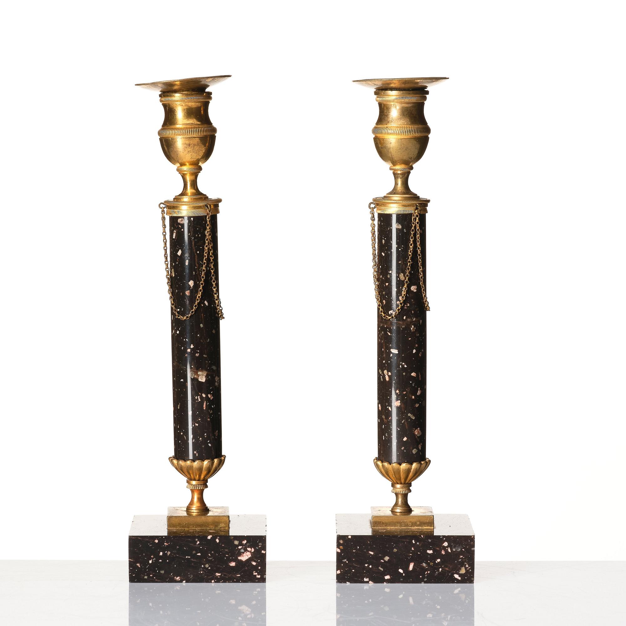 A pair of late Gustavian porphyry and gilt brass candlesticks, circa 1800.