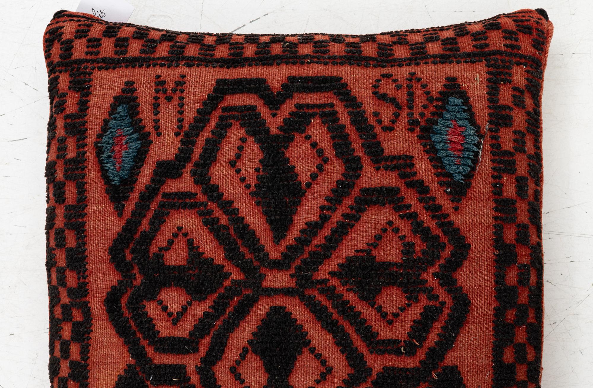 A carriage cushion, knotted pile in relief, ca 106 x 47, southwest of Scania, Sweden, circa 1800.