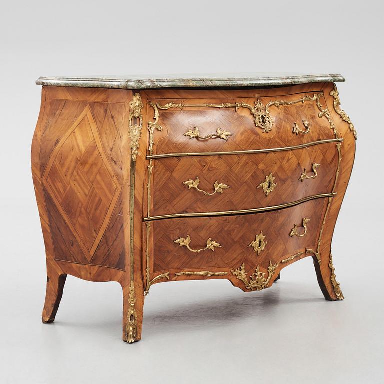 A rococo parquetry and gilt brass-mounted commode by J. J. Eisenbletter (active ca 1760-1810).
