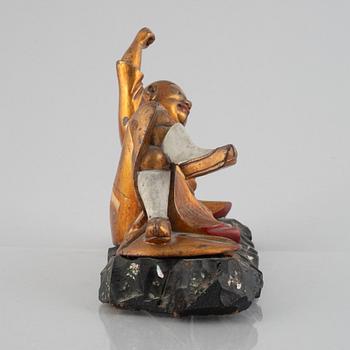 A Chinese lacquered and gilt wood figure, 20th century.