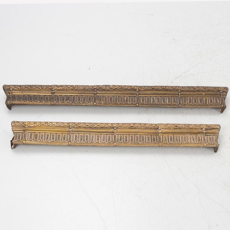 Two repousse-brass cornices, circa 1900.