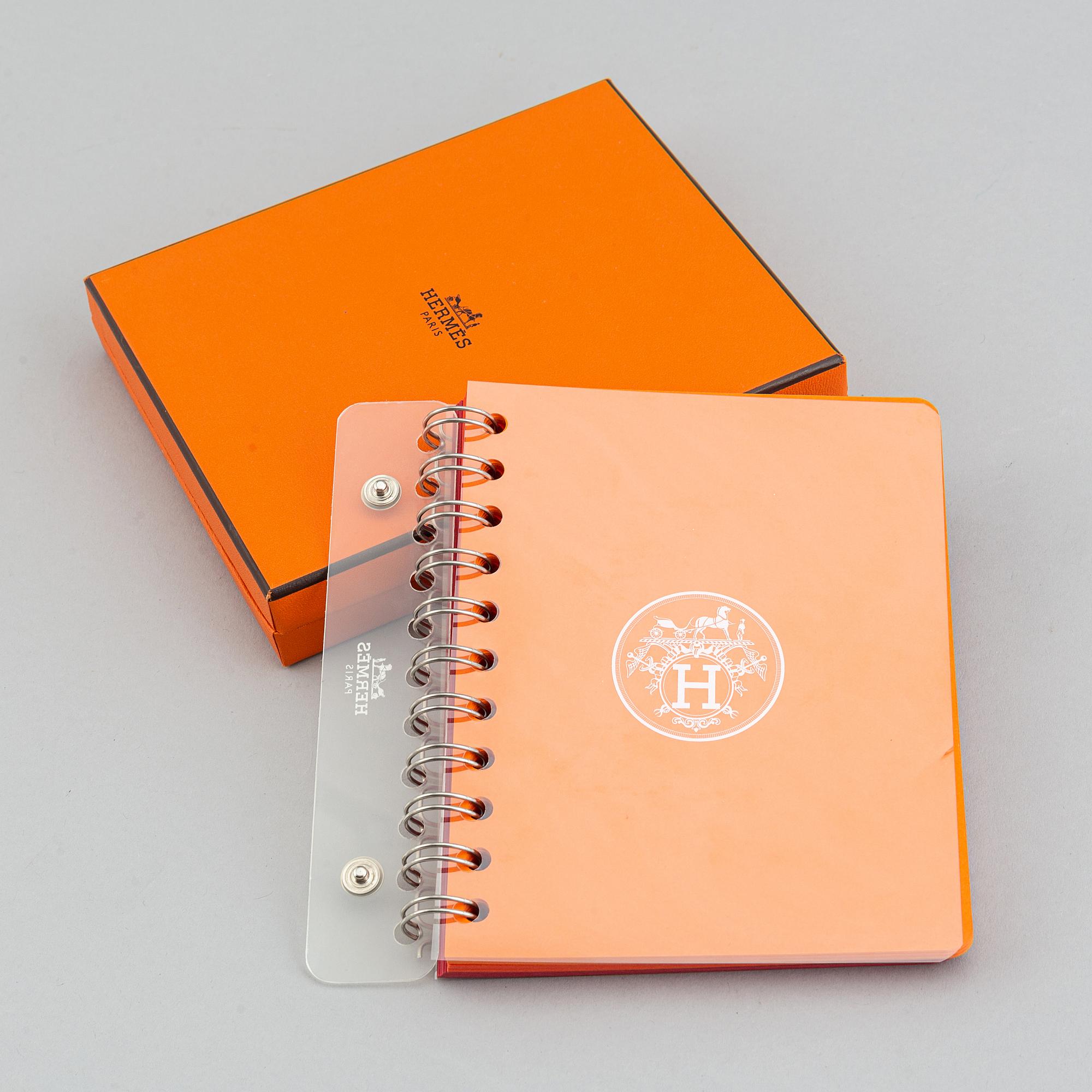 Hermès, a blue leather notebook with two scripple pads.