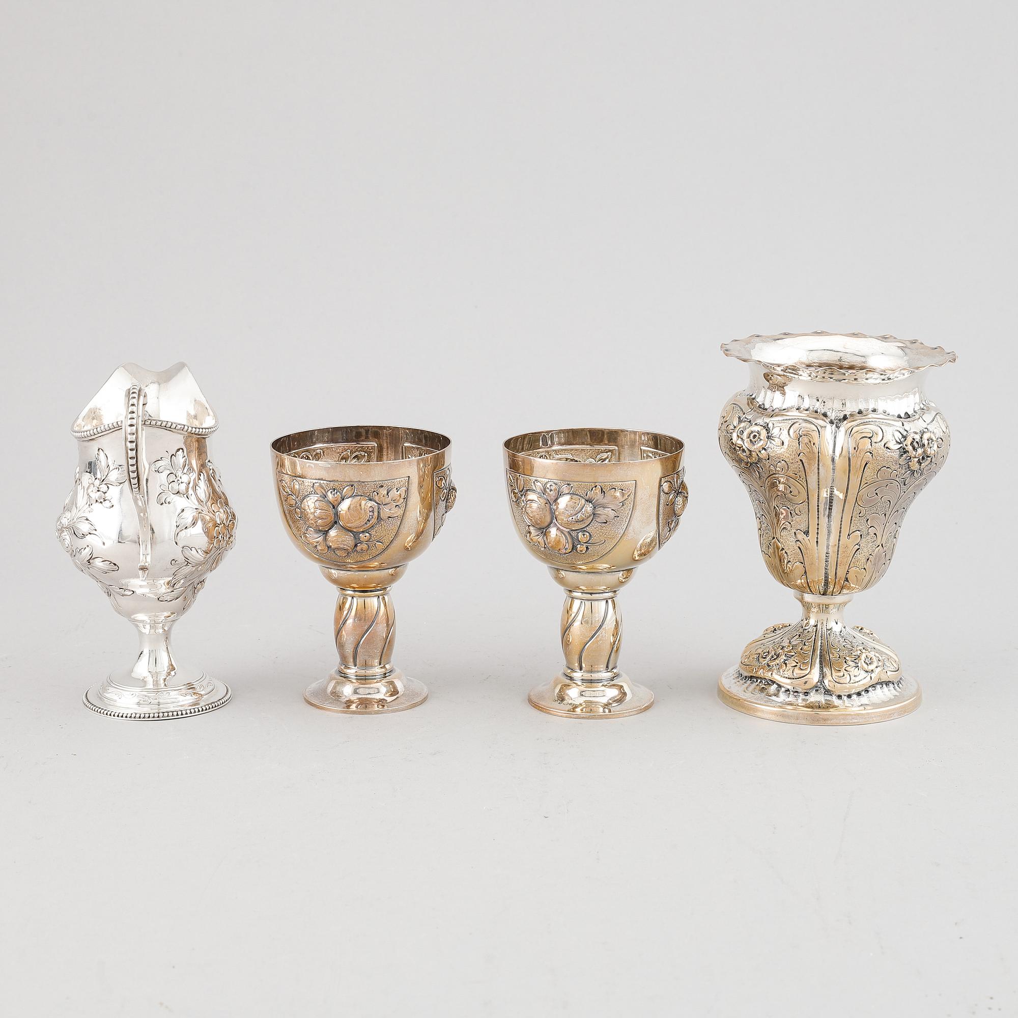 A mixed lot of two beakers, a vase and a jug, Baroque style, silver 830, 20th century.