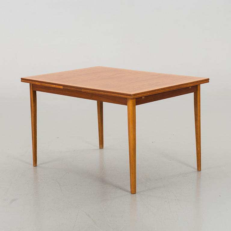 A TEAK DINNER TABLE.